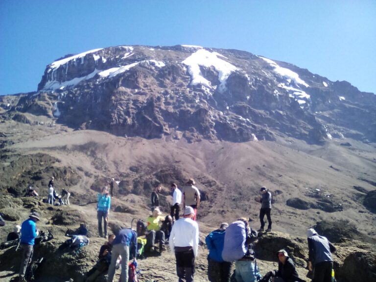Group of climbers trekking on the Machame Route near a peak on Mount Kilimanjaro