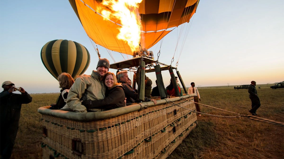Hot air balloon floating over the Serengeti plains at sunrise