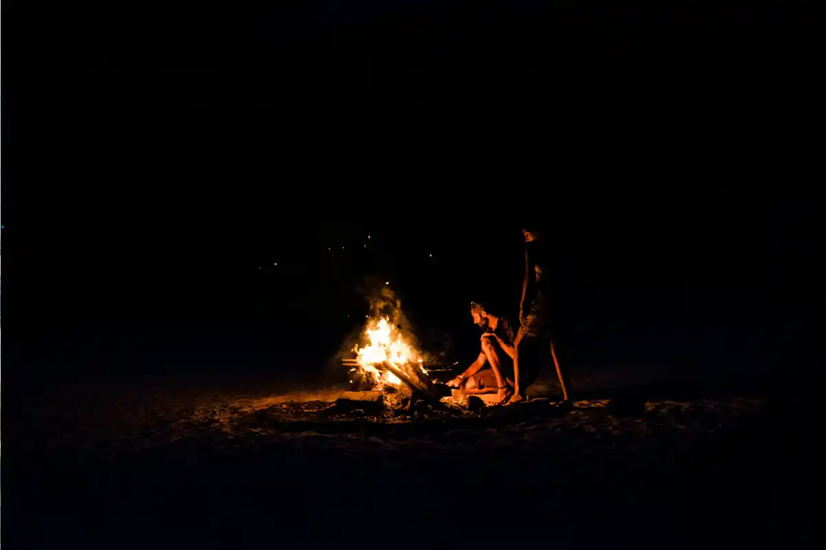 Travelers enjoying a campfire on a Tanzania group safari