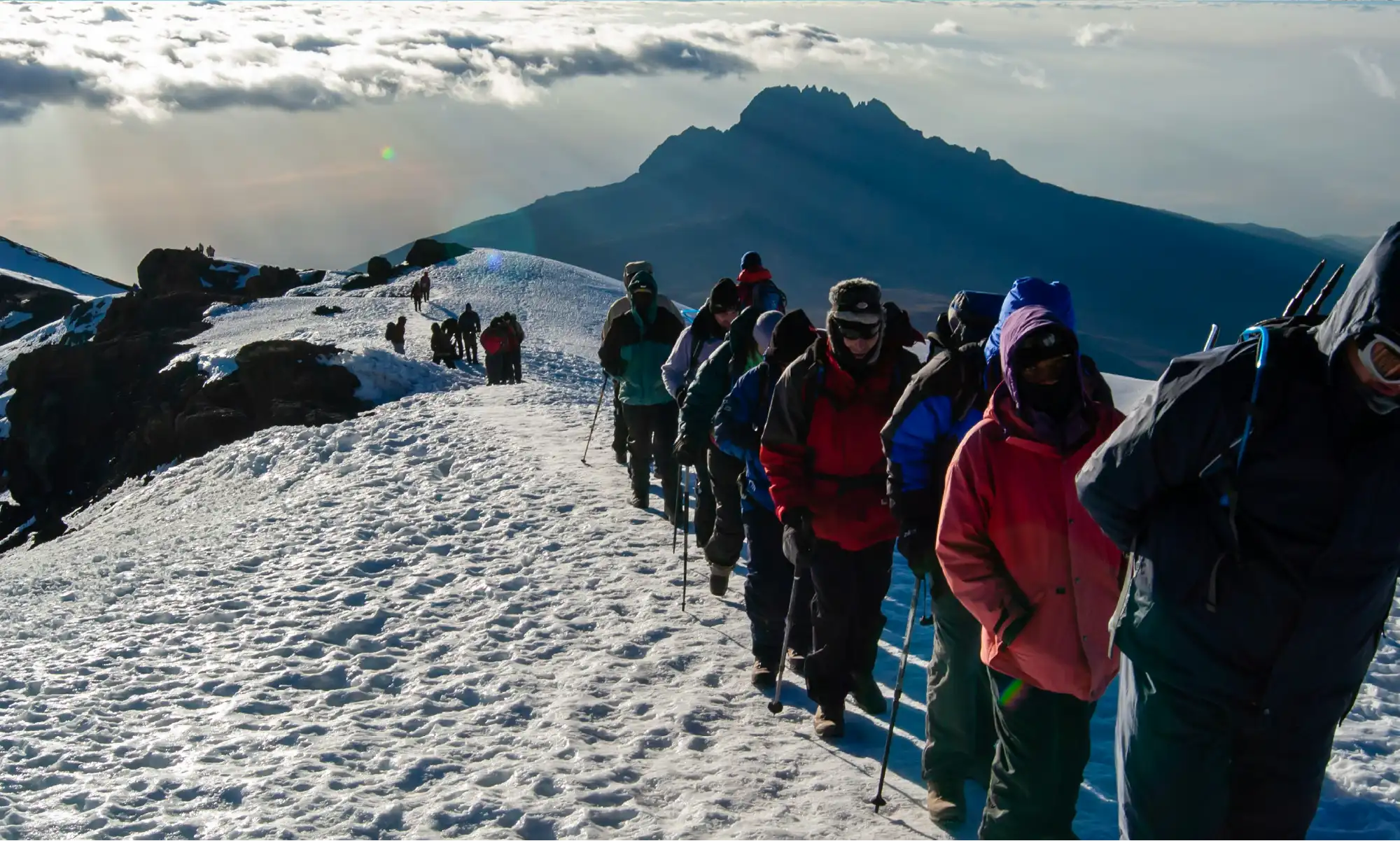Climbers ascending Mount Kilimanjaro at sunrise