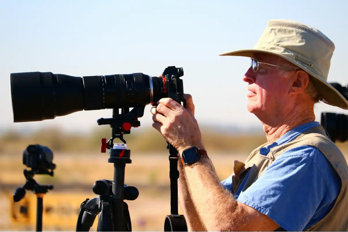 Traveller with a camera in Serengeti overlooking the plains