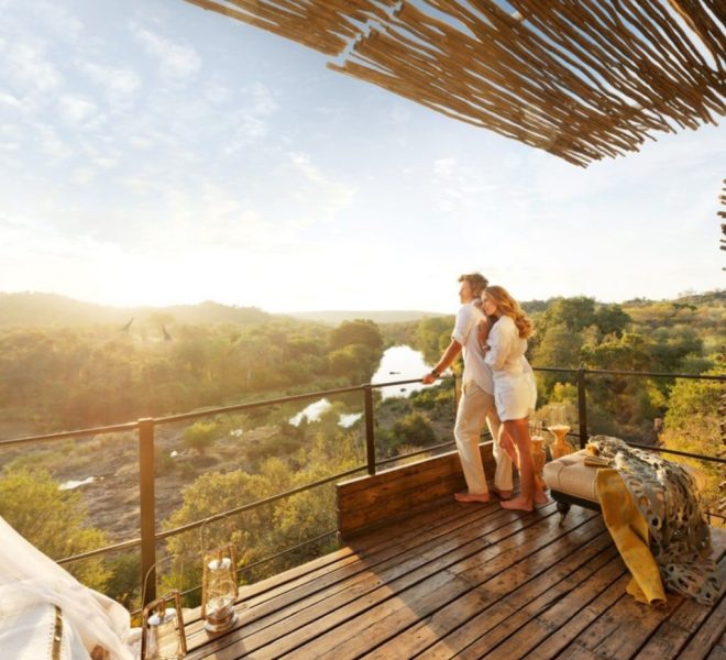 a couple in serengeti national parkenjoying the sunrise on their honeymoon safari