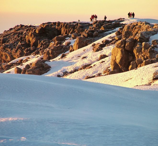 Hiking to the top of the mountain, Mt Kilimanjaro with lots of snow, rocks and a great sunrise