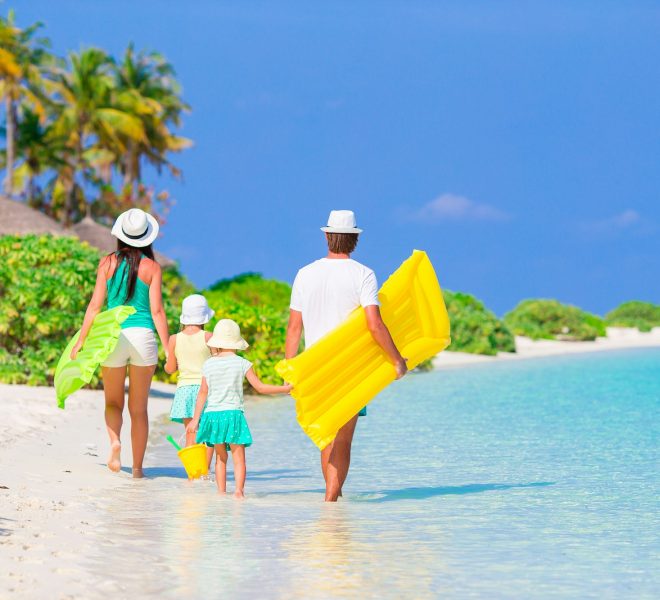 Family enjoying the beach in Zanzibar, relaxing by the ocean during their safari and beach escape.